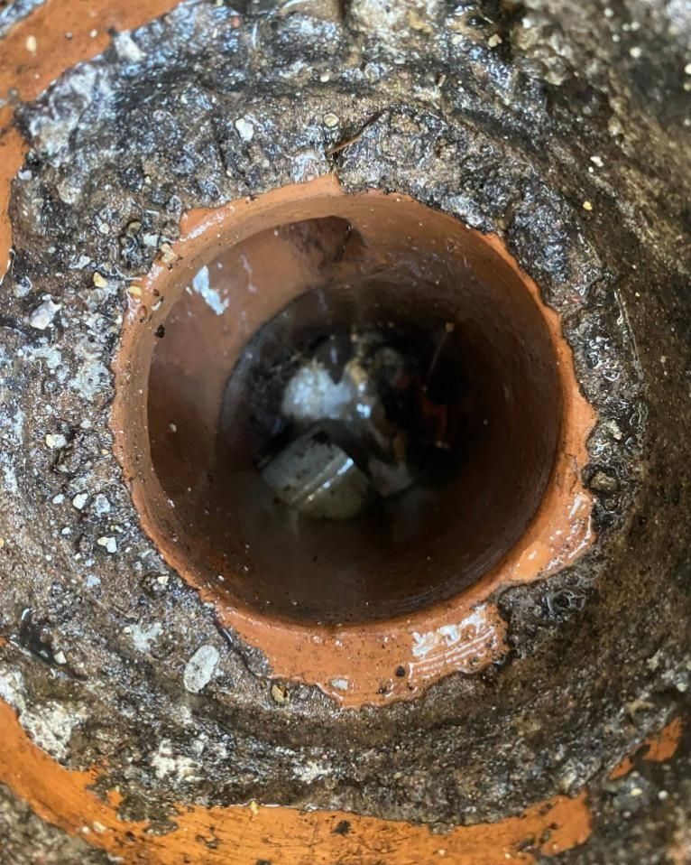 A Close Up of a Hole in a Brick Wall With Water Coming Out of It — Nightcliff Plumbing & Gas In Stuart Park, NT