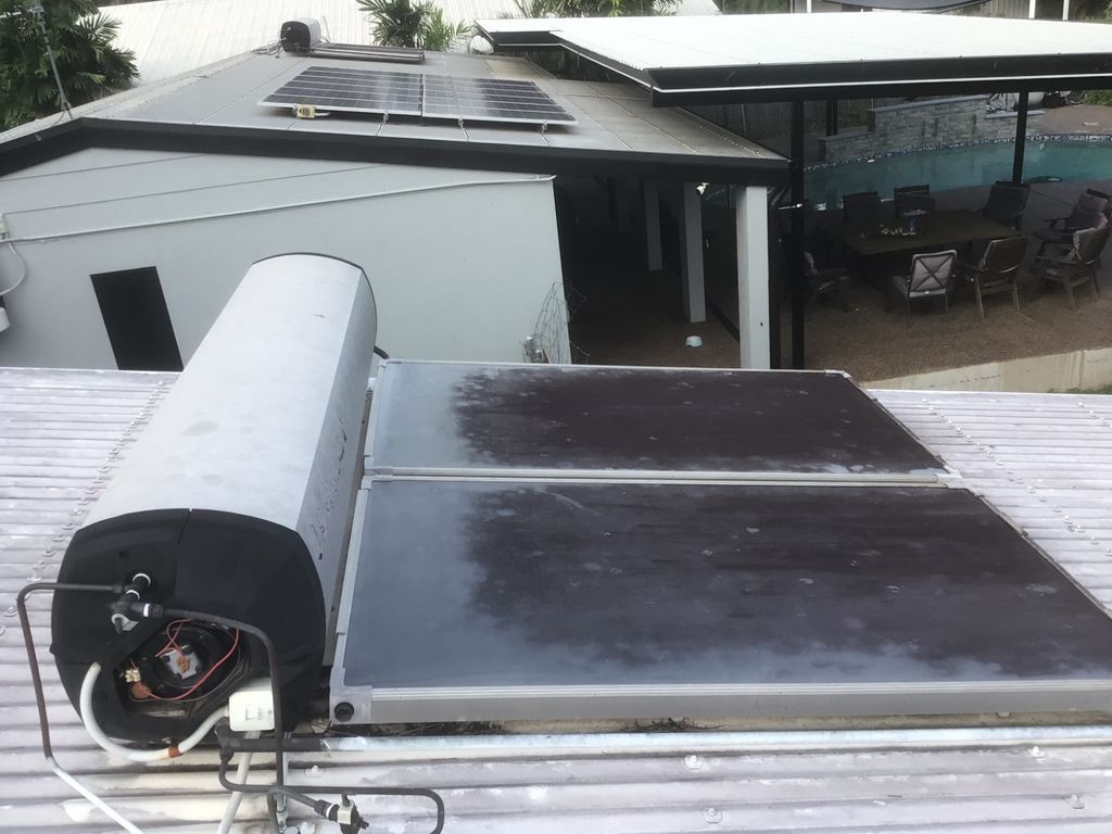 A Roof With a Water Heater and Solar Panels on It — Nightcliff Plumbing & Gas In Coconut Grove, NT