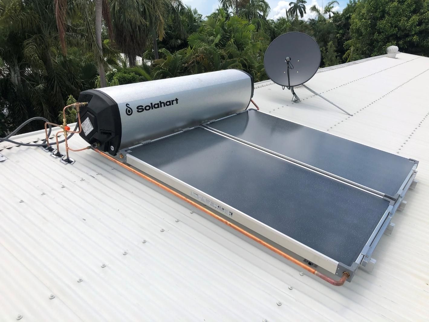 A Solar Water Heater is Sitting on Top of a White Roof — Nightcliff Plumbing & Gas In Leanyer, NT