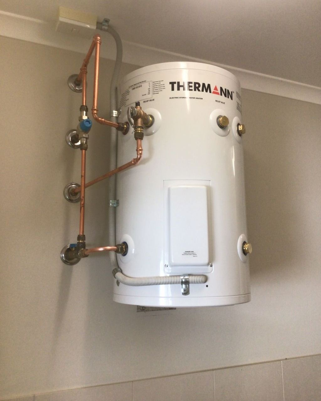 A White Thermos With Copper Pipes Attached to It — Nightcliff Plumbing & Gas In Palmerston, NT