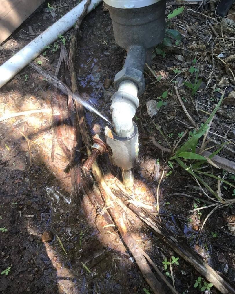 A Water Meter is Sitting in the Dirt Next to a Pipe — Nightcliff Plumbing & Gas In Parap, NT