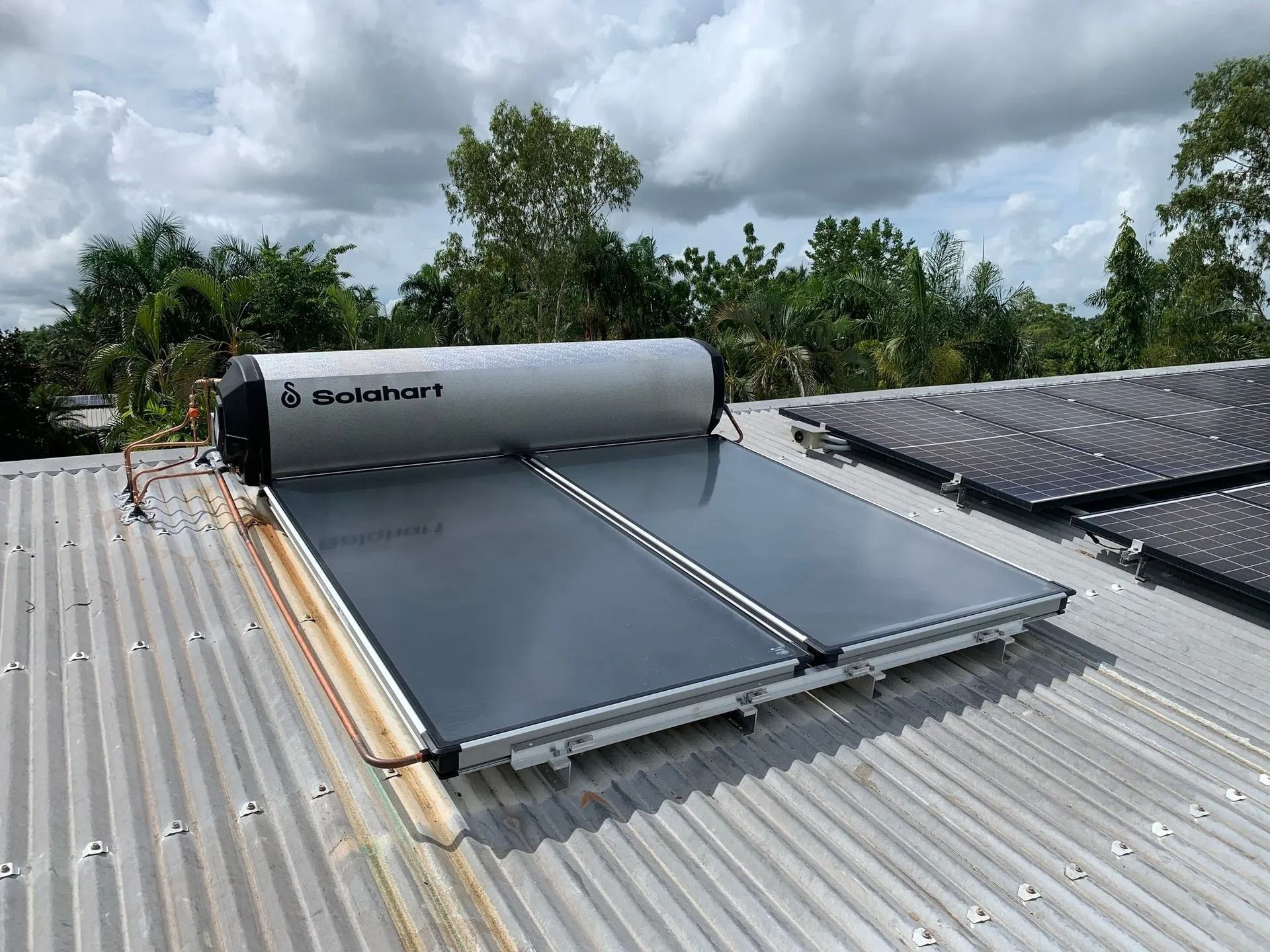 A Solar Water Heater is Sitting on Top of a Metal Roof — Nightcliff Plumbing & Gas In Howard Springs, NT