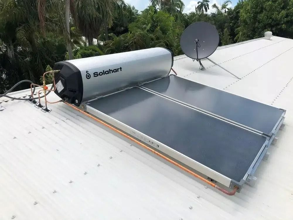 A Solar Water Heater is Sitting on Top of a White Roof — Nightcliff Plumbing & Gas In Coconut Grove, NT