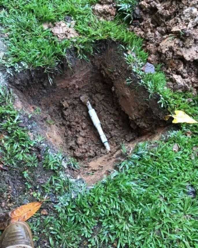 A Person is Standing Next to a Hole in the Ground With a Pipe in It — Nightcliff Plumbing & Gas In Coconut Grove, NT