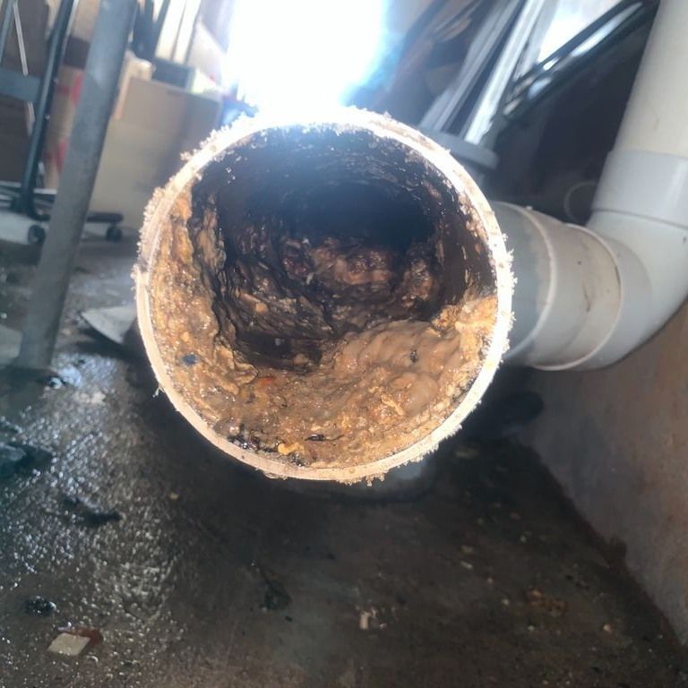 A Close Up of a Pipe With a Lot of Dirt in It — Nightcliff Plumbing & Gas In Berrimah, NT