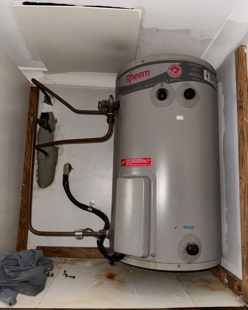 A Water Heater is Sitting in a Corner of a Room — Nightcliff Plumbing & Gas In Berrimah, NT