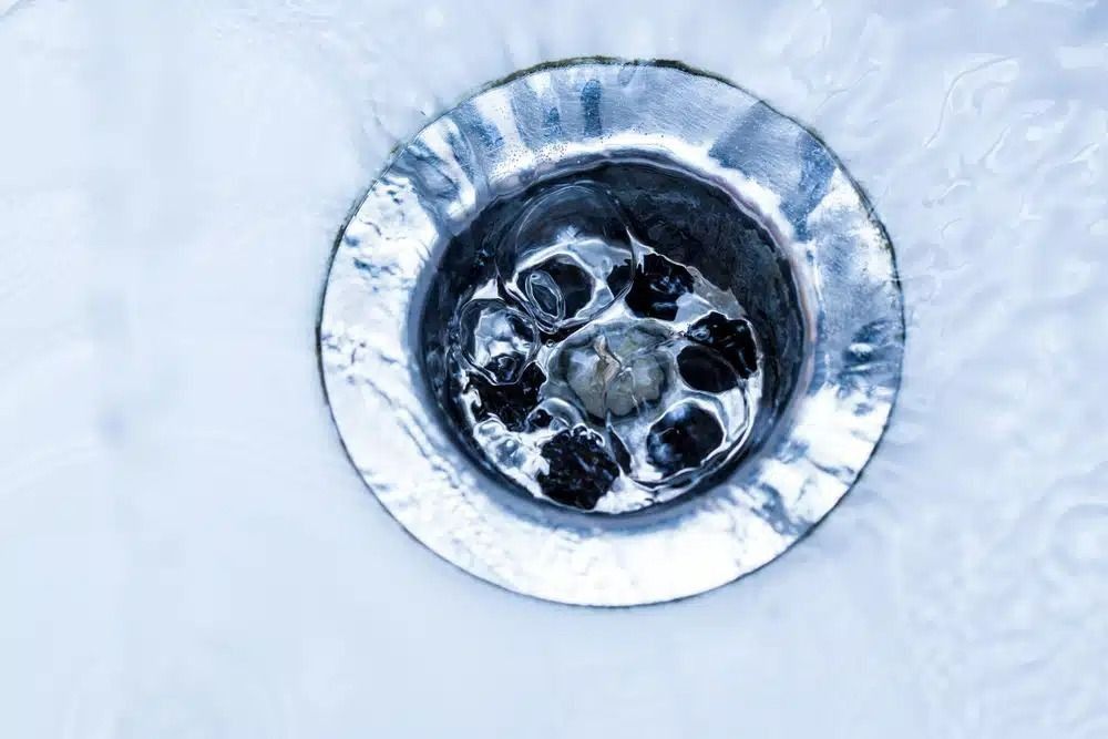 A Close Up of a Sink Drain With Water Running Down It — Nightcliff Plumbing & Gas In Coconut Grove, NT