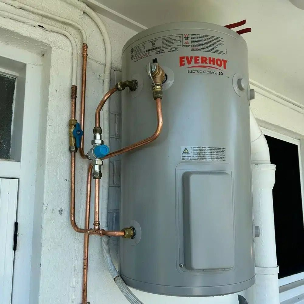 A Grey Everhot Water Heater With Copper Pipes Attached to It — Nightcliff Plumbing & Gas In Coconut Grove, NT