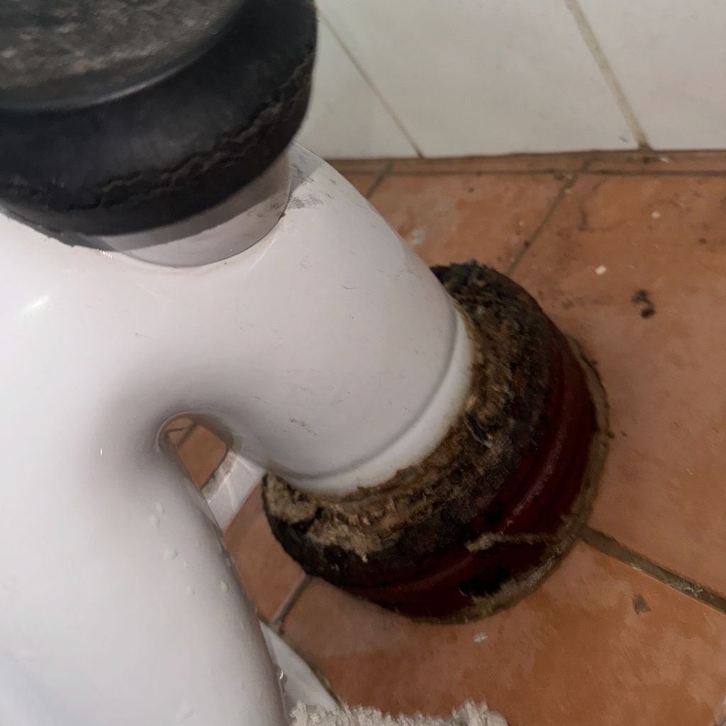 A White Pipe With a Black Cap is Sitting on a Tiled Floor — Nightcliff Plumbing & Gas In Coconut Grove, NT