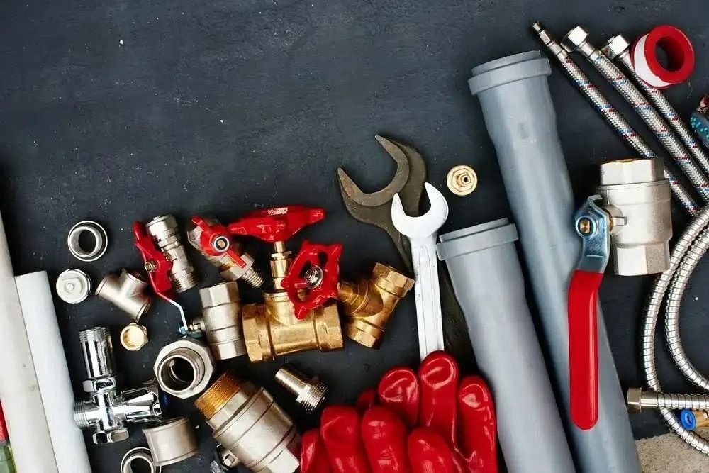 A Bunch of Plumbing Tools and Pipes on a Table — Nightcliff Plumbing & Gas In Coconut Grove, NT