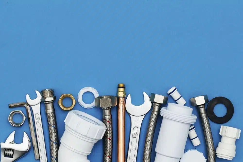 A Bunch of Plumbing Tools on a Blue Background — Nightcliff Plumbing & Gas In Coconut Grove, NT