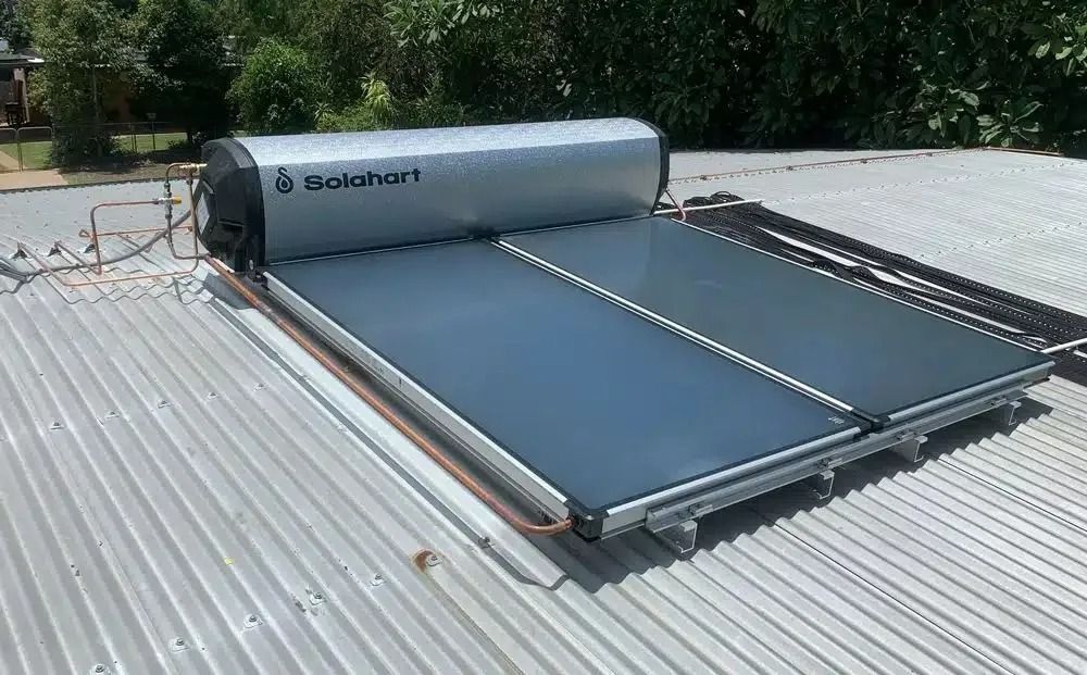 A Solar Water Heater is Sitting on Top of a Metal Roof — Nightcliff Plumbing & Gas In Coconut Grove, NT