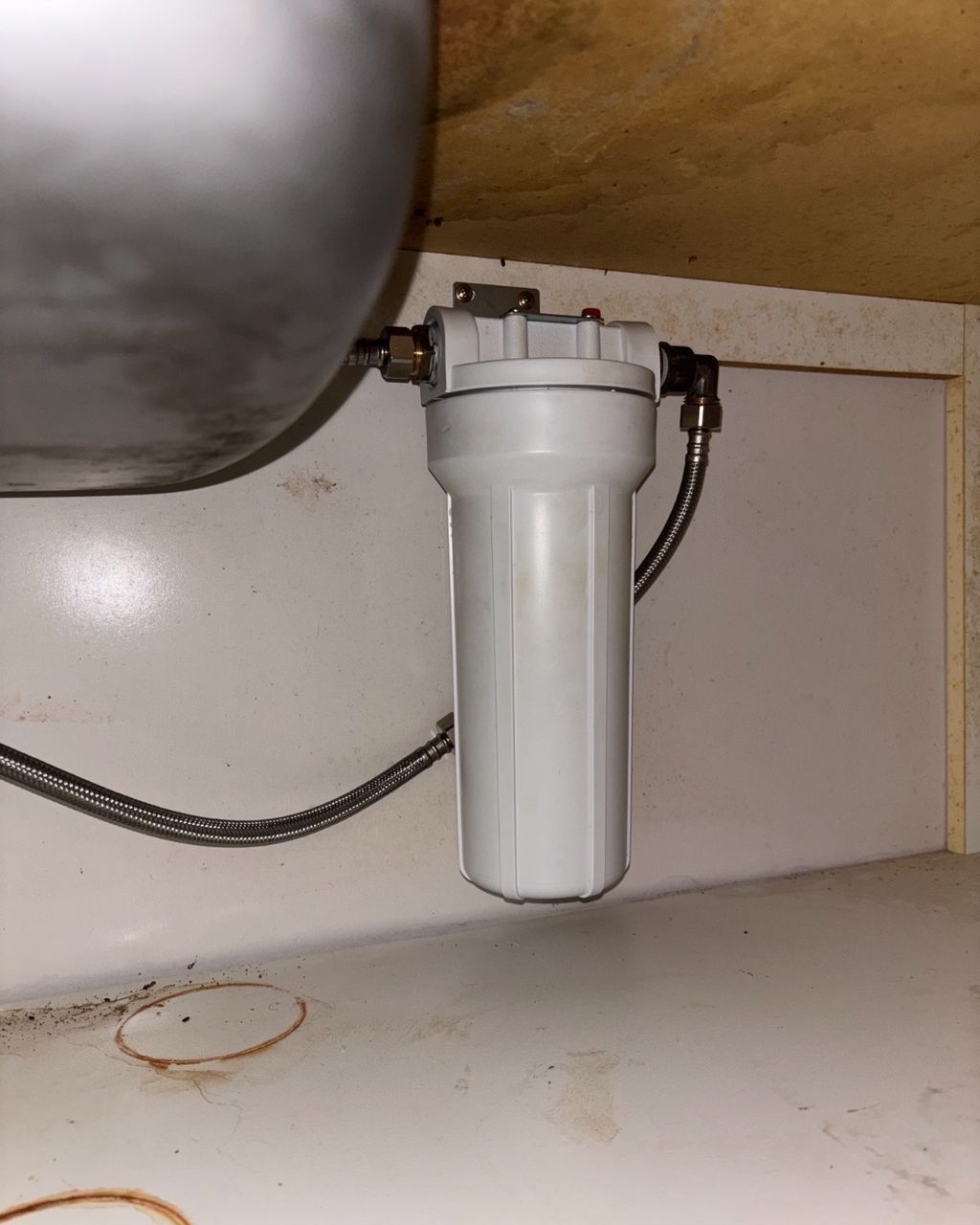 A Water Filter is Sitting Under a Sink in a Kitchen — Nightcliff Plumbing & Gas In Coconut Grove, NT
