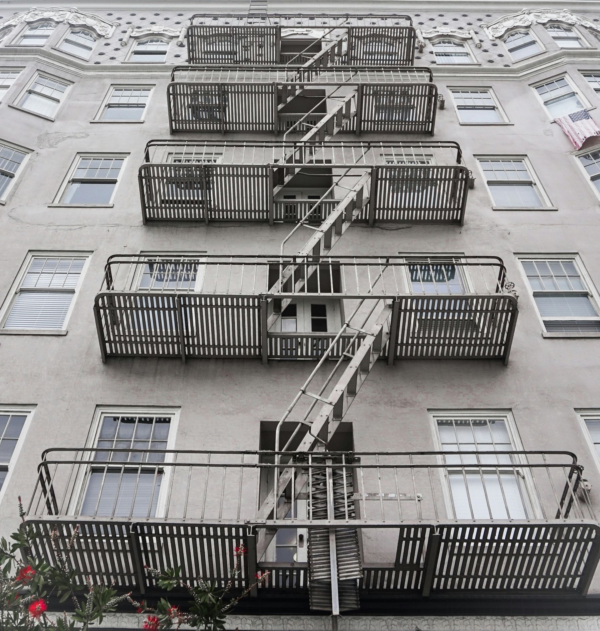 Los Gatos apartment building facade with stacked metal fire escapes and balconies