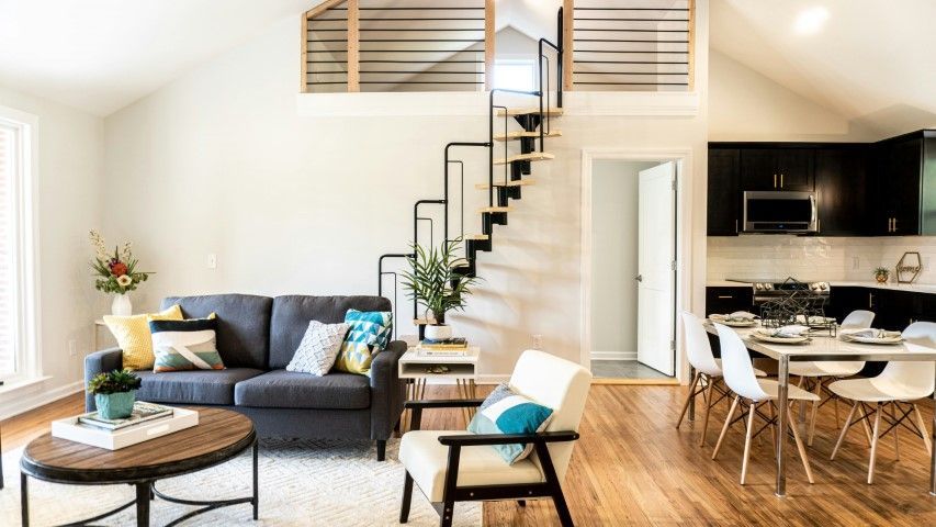 Floating stairs connecting living room and kitchen