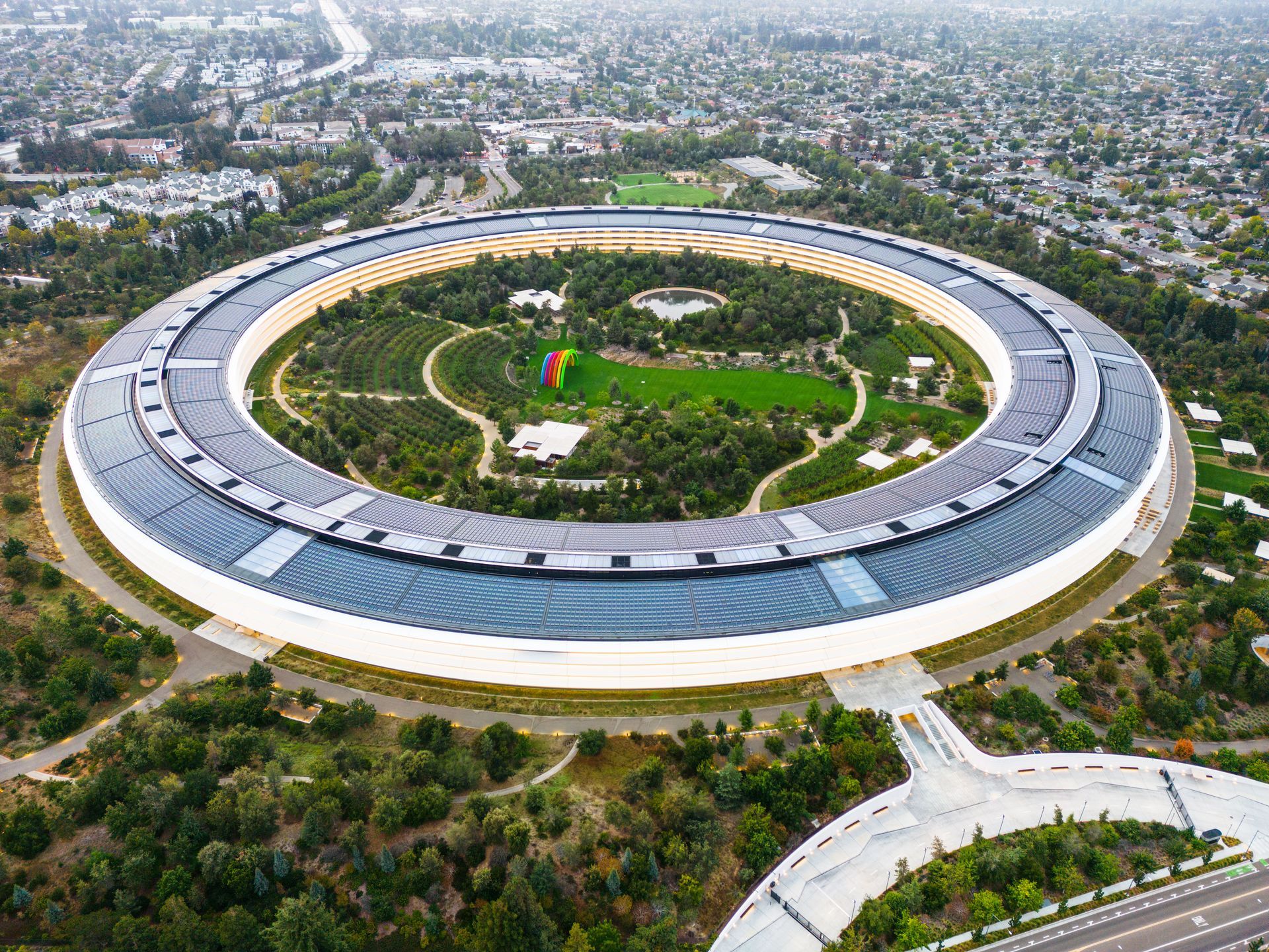 Aerial view of Apple Park’s circular campus with solar roof and green inner garden.