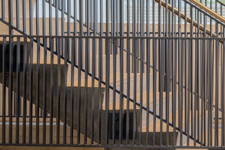 Gray metal and wood staircase over concrete steps in Sunnyvale, CA.
