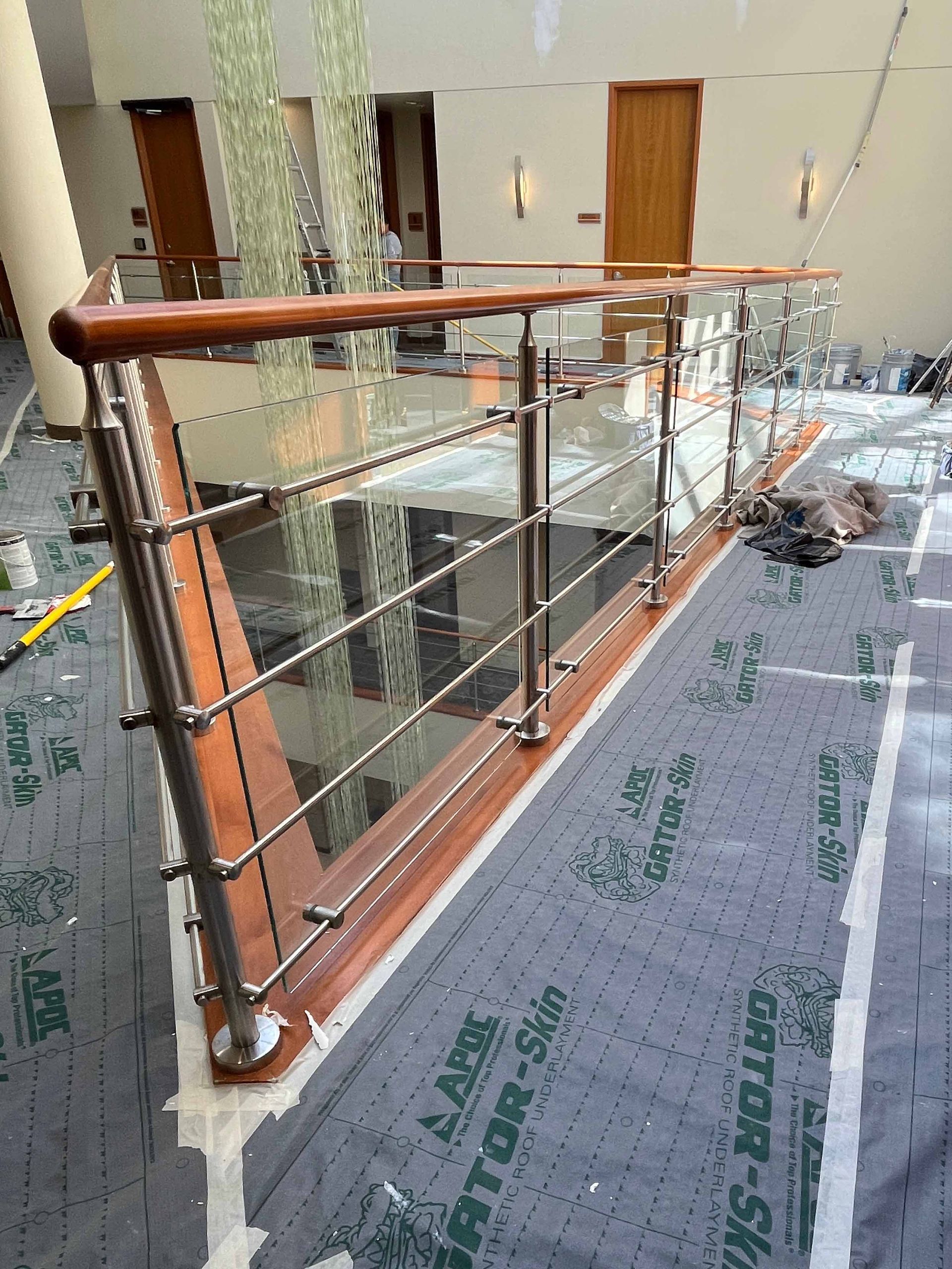 glass railing with wood top caps and metal posts and bars