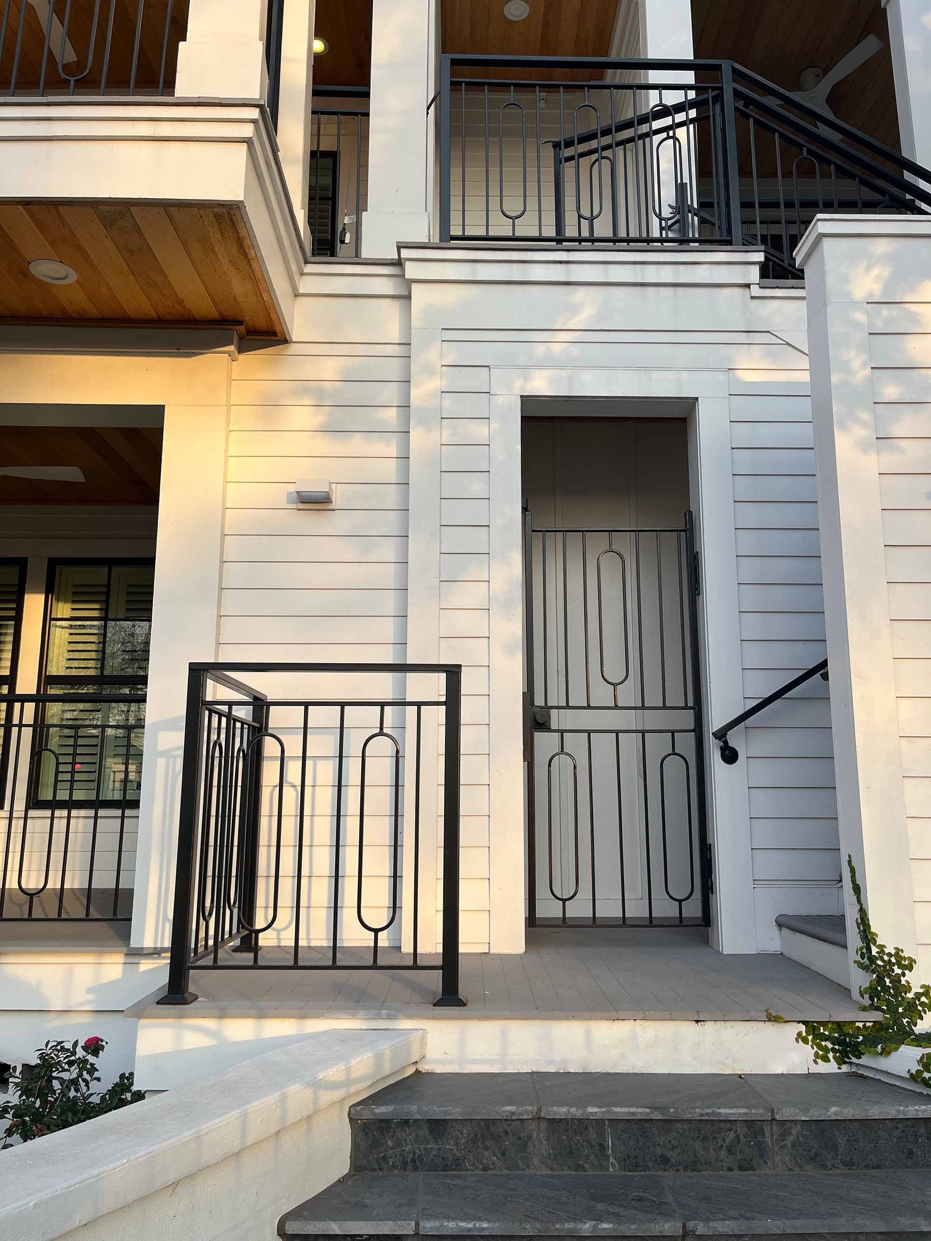 Modern concept railing with matching gate and balcony rails on exterior of home