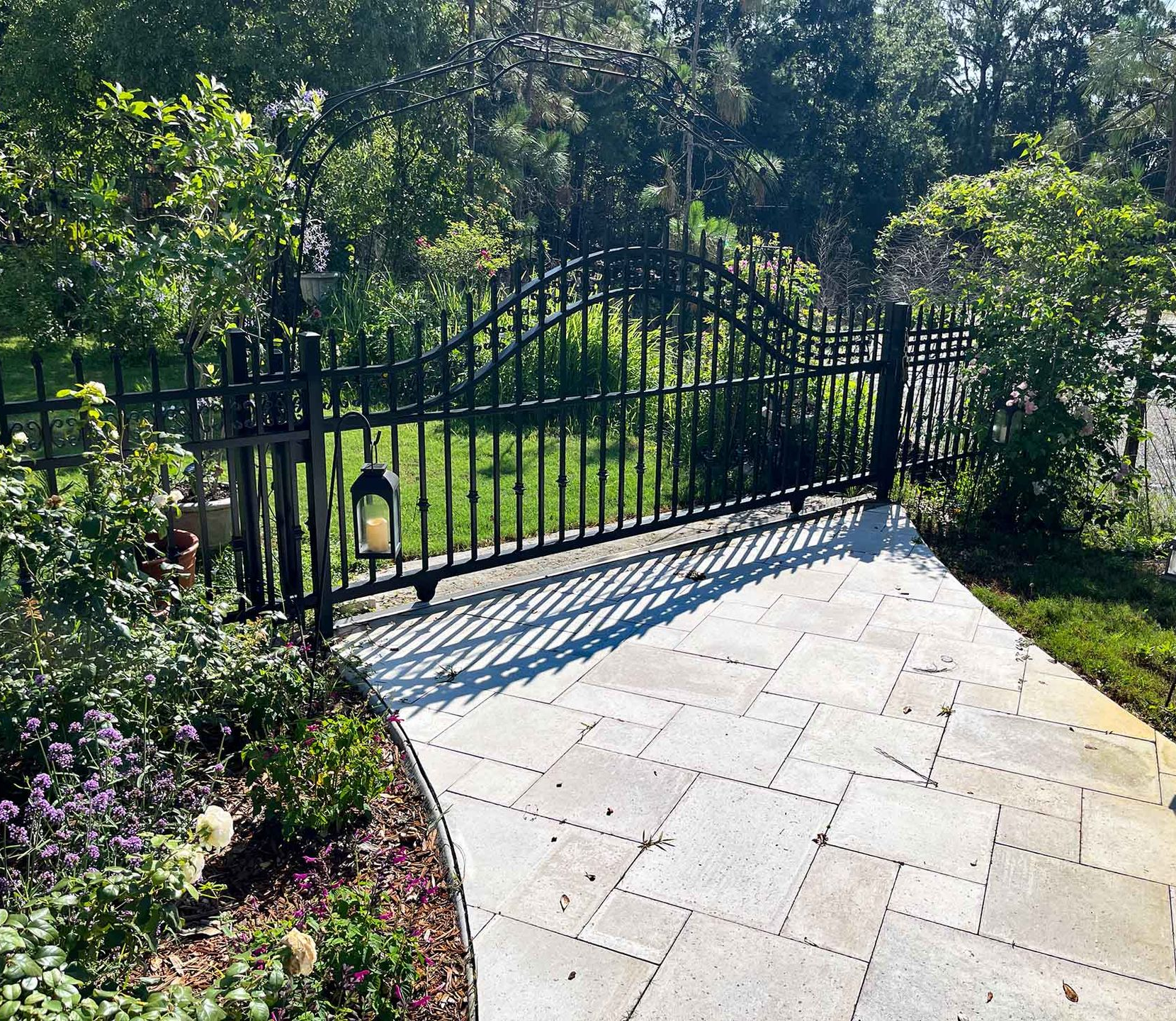 black custom gate with matching fence at yard entrance