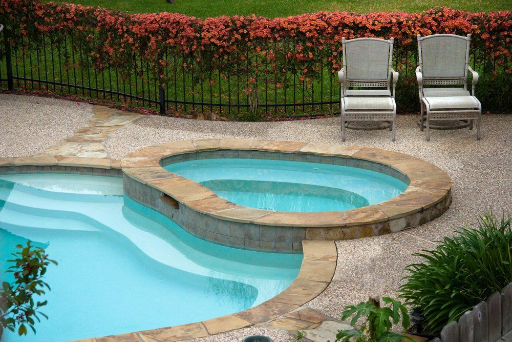 There Is a Swimming Pool with A Hot Tub in The Middle of It — Topline Aluminium Forster Pty Ltd in Taree, NSW