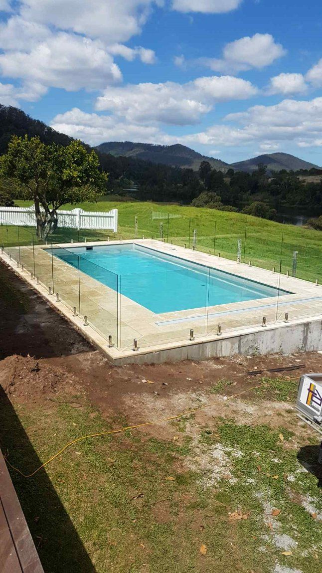 Swimming Pool Is Surrounded by A Fence — Topline Aluminium Forster Pty Ltd in Taree, NSW