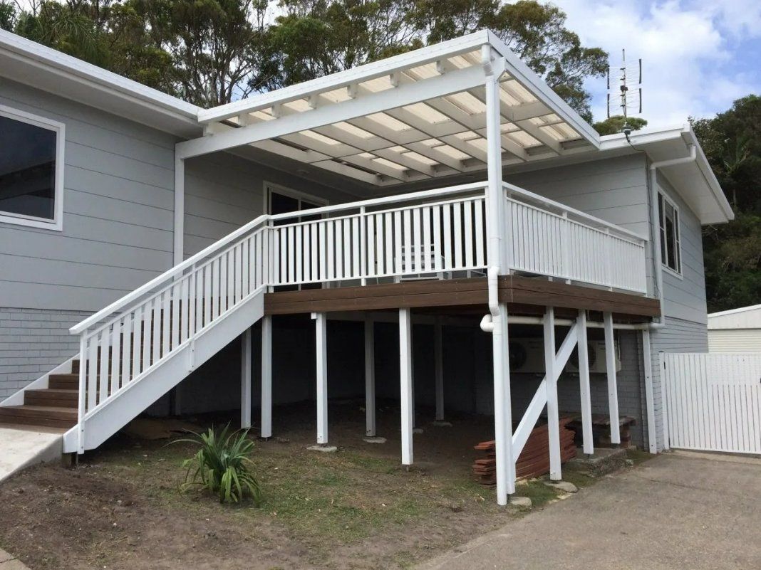 A White House with Stairs Leading up To a Deck — Topline Aluminium Forster Pty Ltd in Forster, NSW
