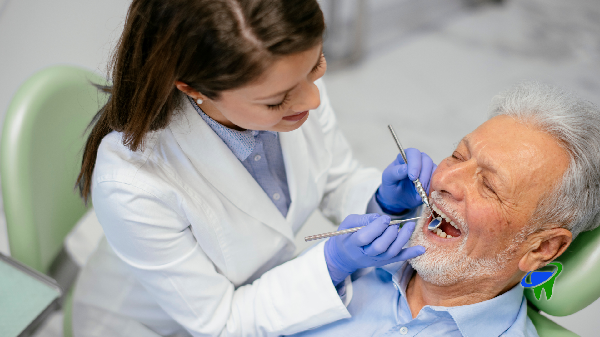 Dentist examining an elderly man's teeth in a dental chair, using blue gloves and tools.