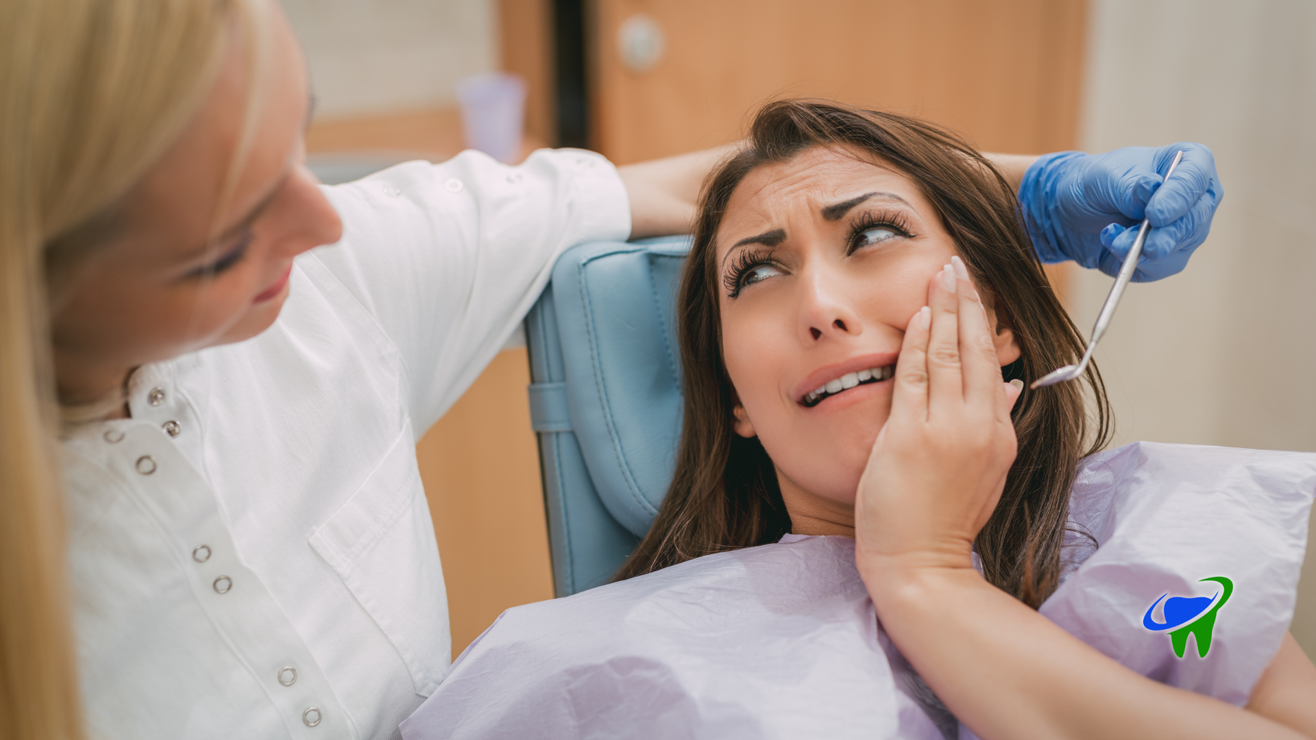 Dentist examining a nervous patient in a dental chair, wearing blue gloves in a clinic.