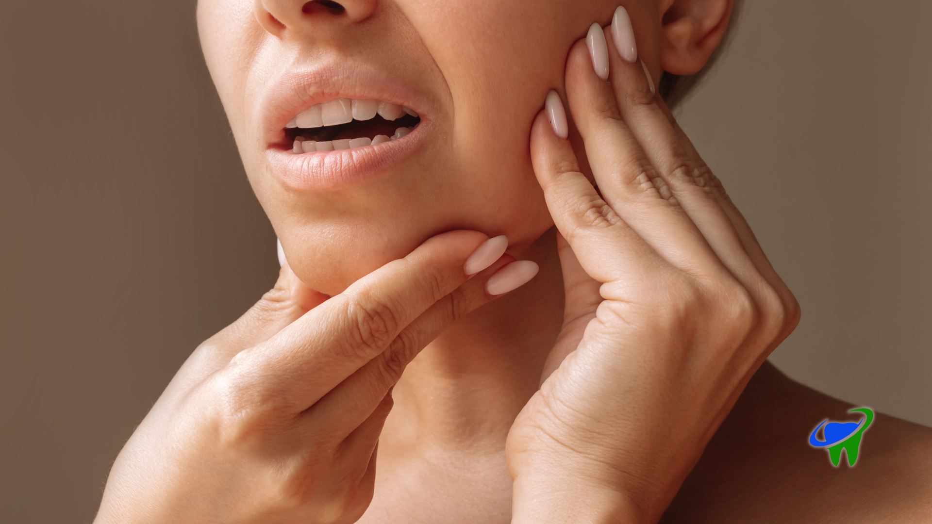 Close-up of a person holding their jaw and cheek, showing mouth pain or discomfort