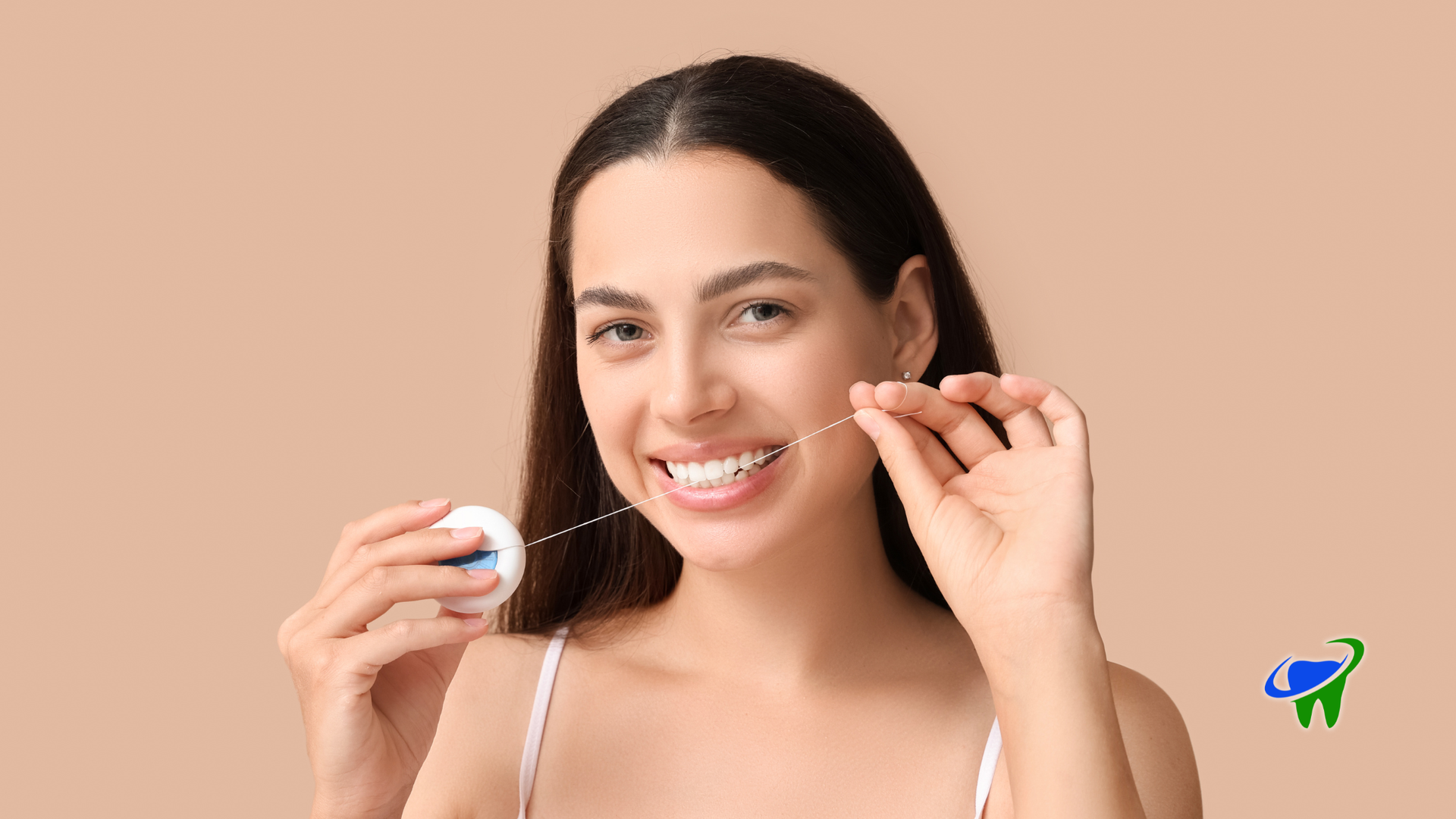 Woman smiling while holding a contact lens case and applying a contact lens against a beige background