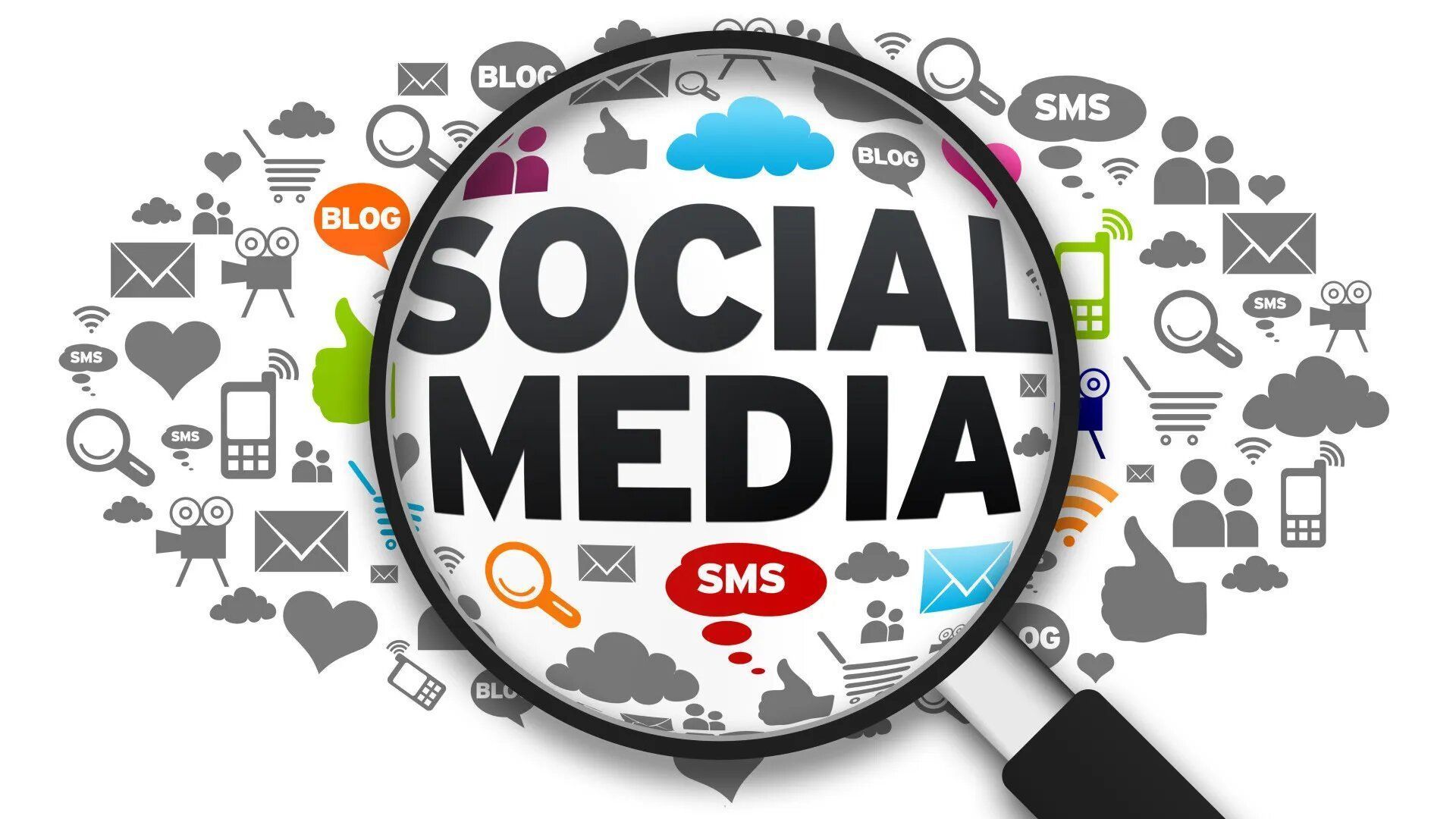 A magnifying glass is looking at the word social media surrounded by icons.