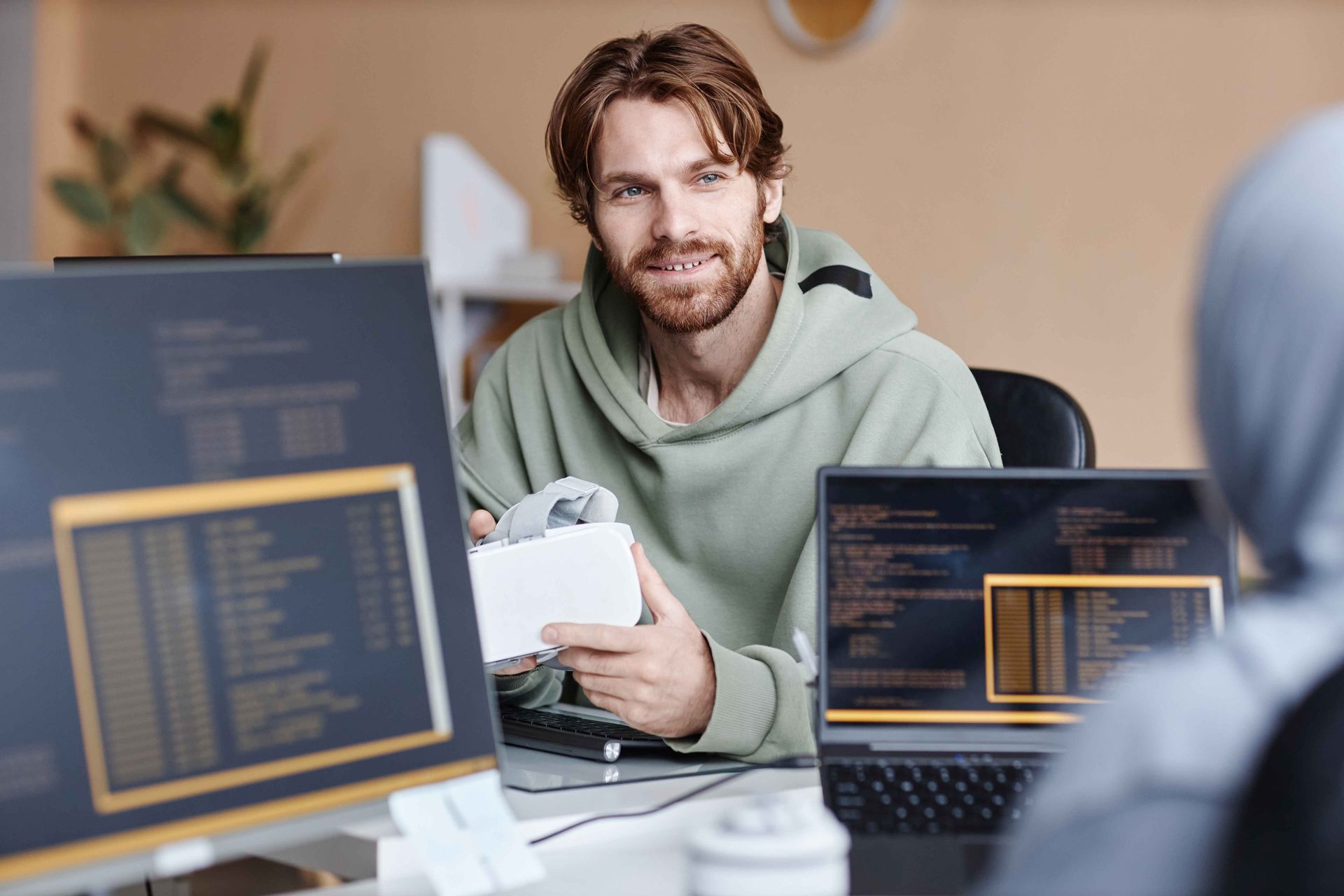 Smiling IT Developer Talking To Colleague in Office