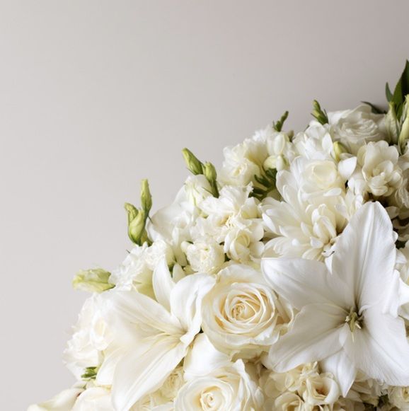 White flower funeral arrangement displayed for memorial services in Walla Walla, WA.