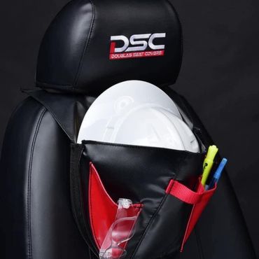 Black DSC seat with white hard hat and red tool pockets holding a clear glove and pens