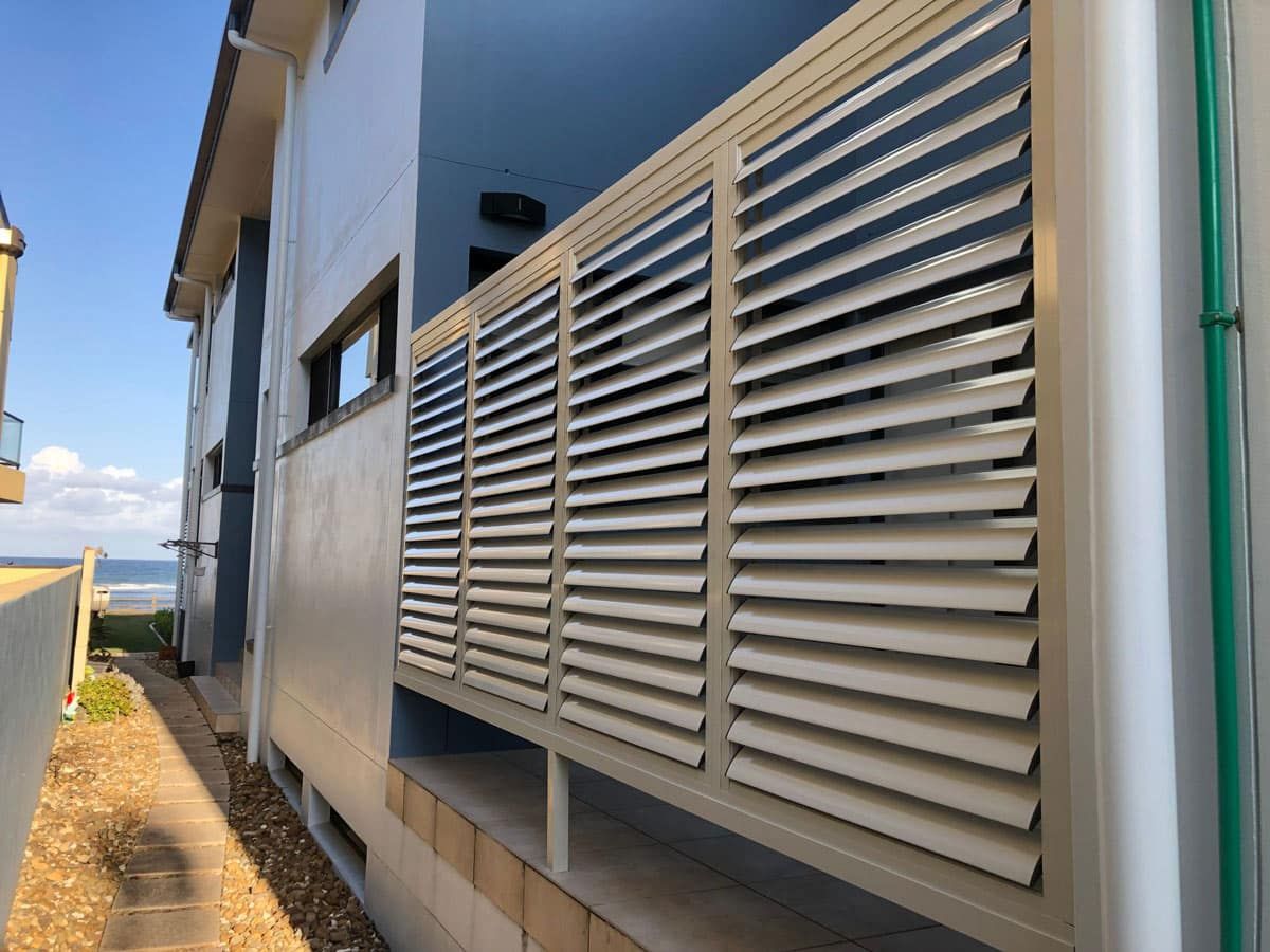 A Building With a Lot of Shutters on the Side of It — TT Shutters & Shading In Yamba, NSW