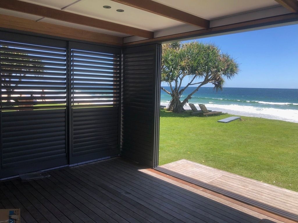 A Room With a View of the Ocean Through a Sliding Glass Door — TT Shutters & Shading In Ballina, NSW