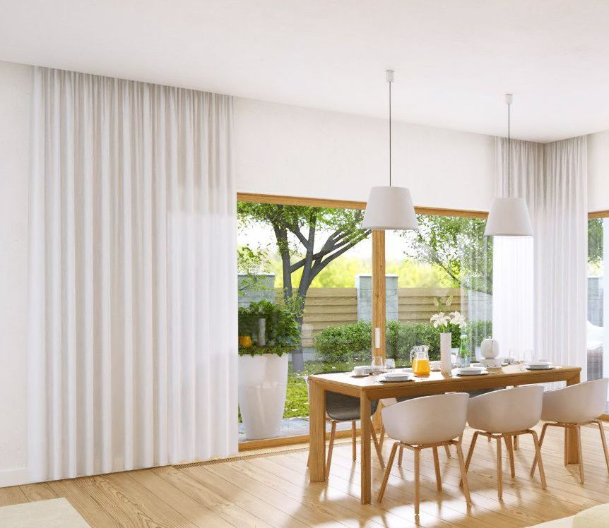 A Dining Room With a Table and Chairs and White Curtains — TT Shutters & Shading In Yamba, NSW