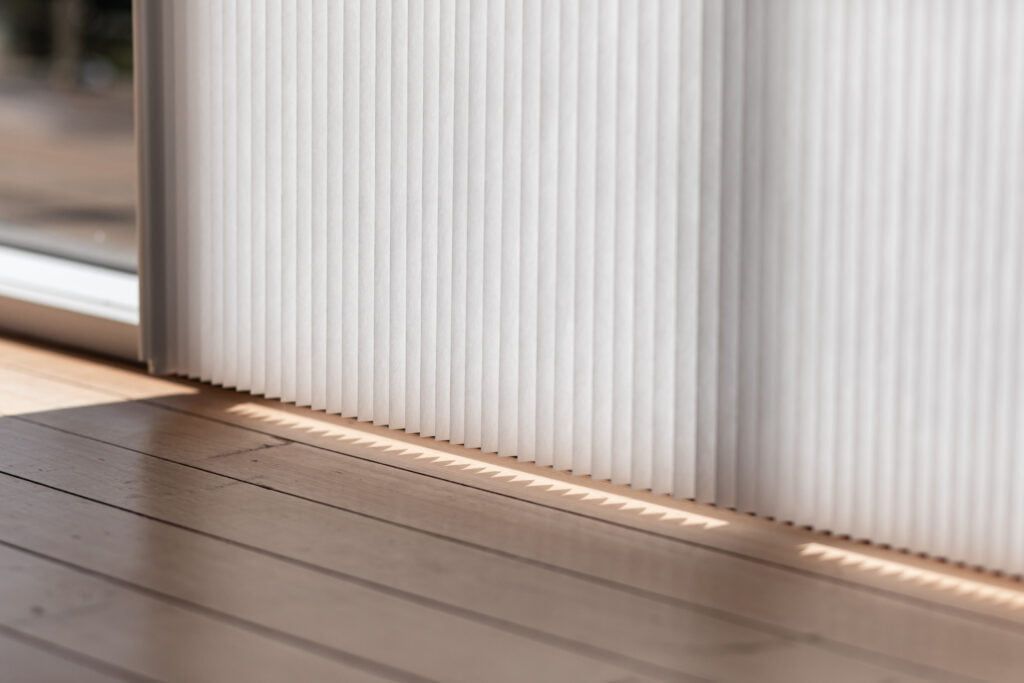 A Close Up of a Window With Blinds on It and a Wooden Floor — TT Shutters & Shading In Ballina, NSW