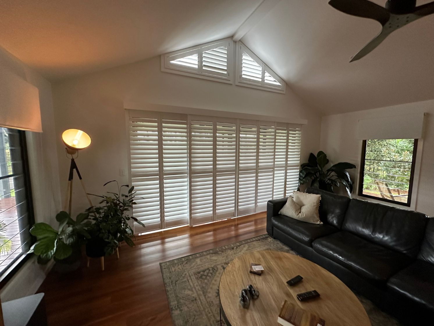 A Living Room With A Couch, Coffee Table, And Ceiling Fan — TT Shutters & Shading In Ballina, NSW