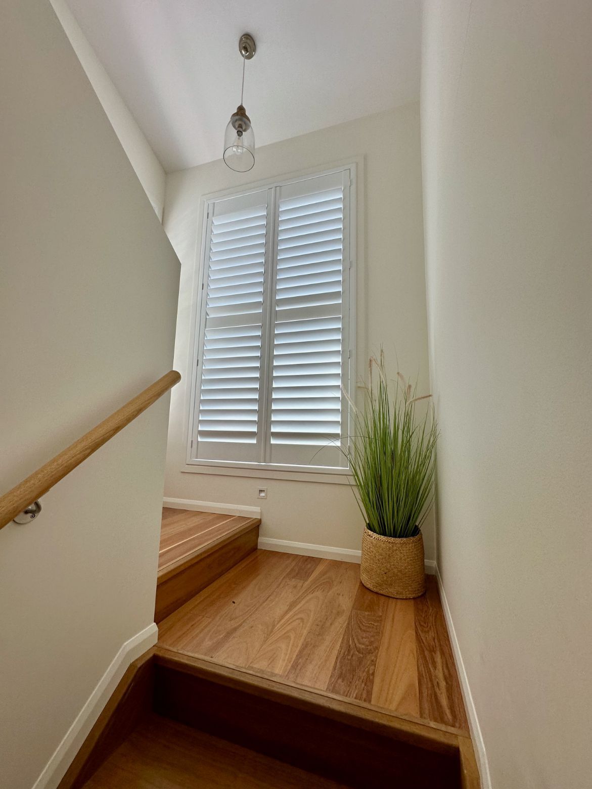 A Room With White Shutters On The Windows And A Wooden Floor — TT Shutters & Shading In Ballina, NSW