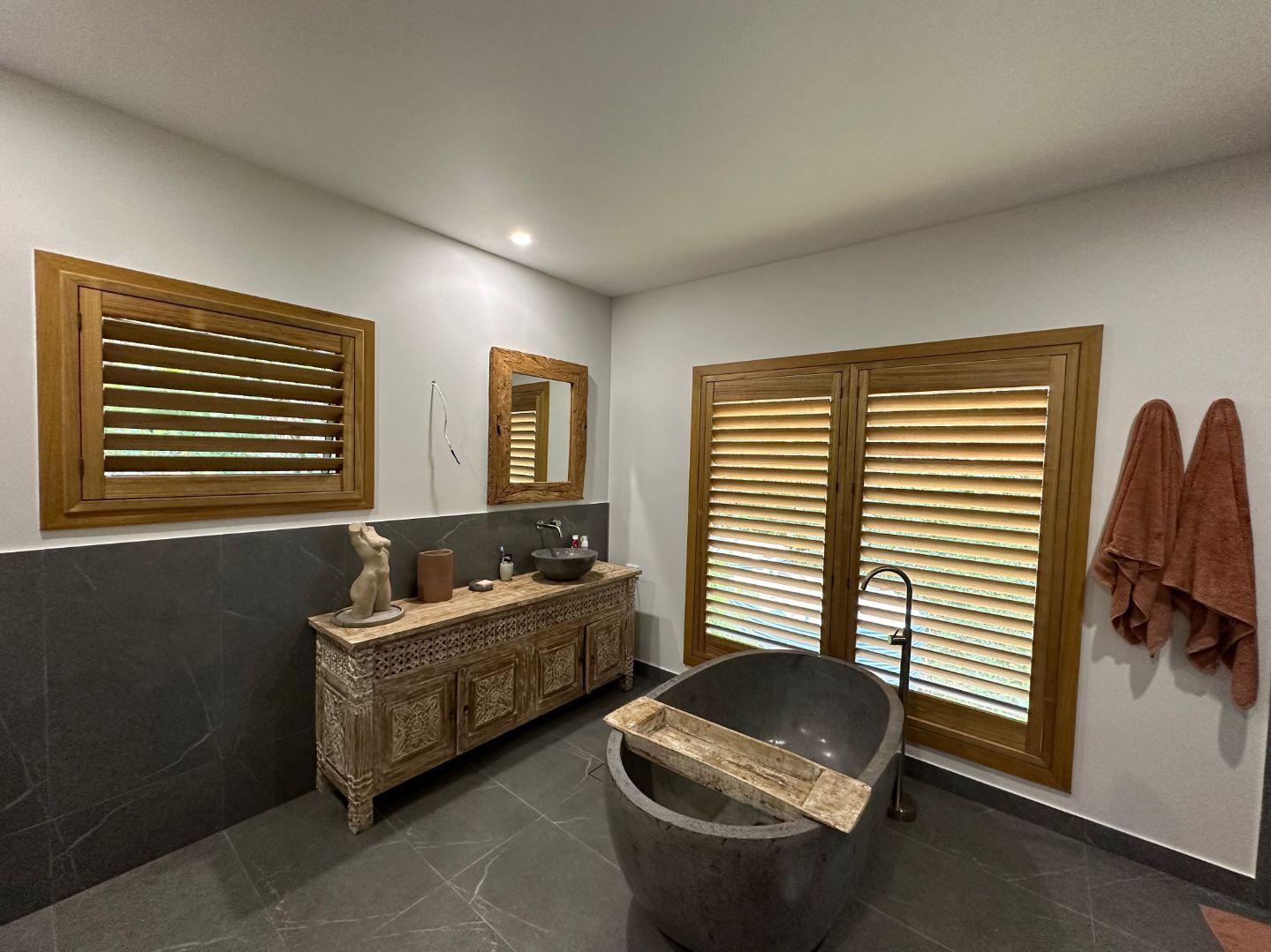 A Bathroom With A Bathtub, Sink , Mirror And Shutters — TT Shutters & Shading In Ballina, NSW