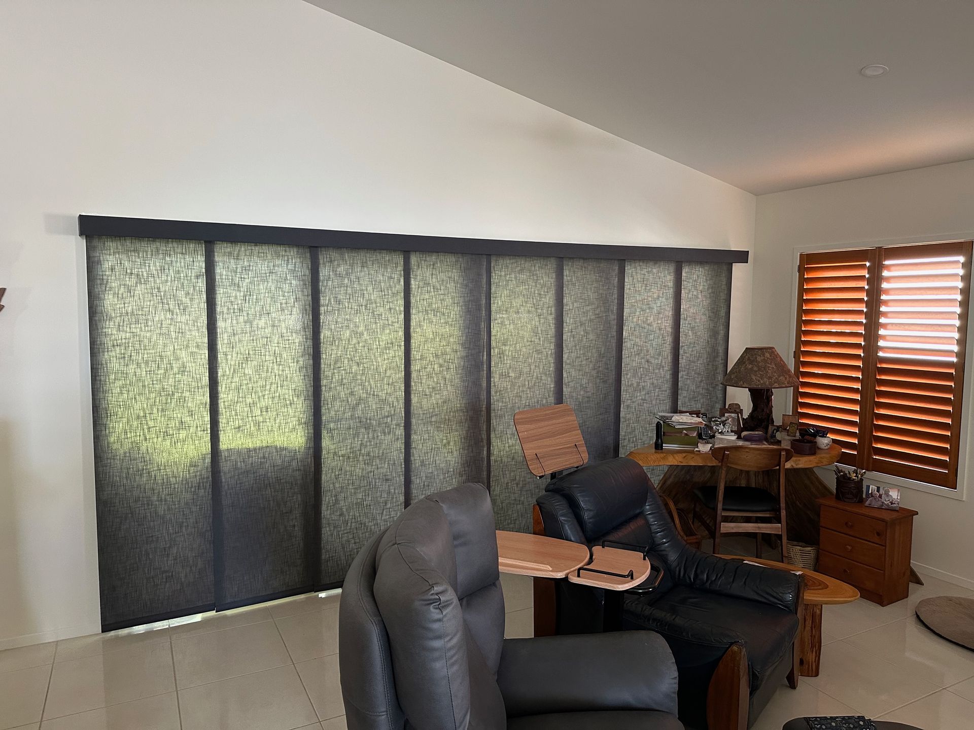 A Dining Room With a Table and Chairs and a Large Window — TT Shutters & Shading In Ballina, NSW