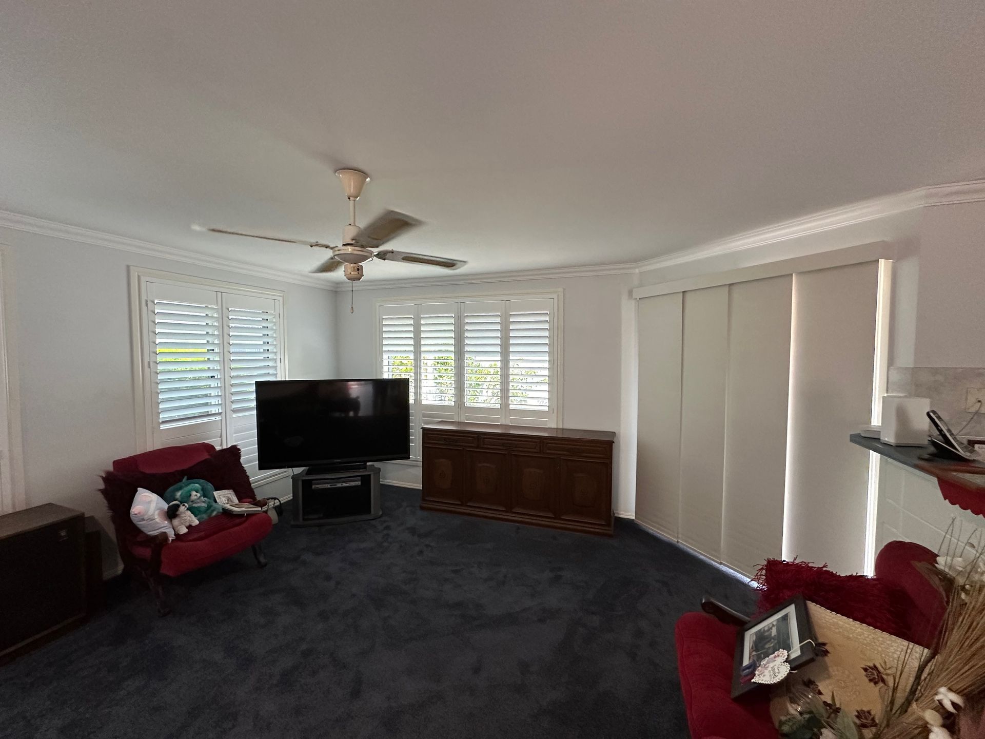 A Living Room With a Ceiling Fan and a Flat Screen Tv — TT Shutters & Shading In Ballina, NSW