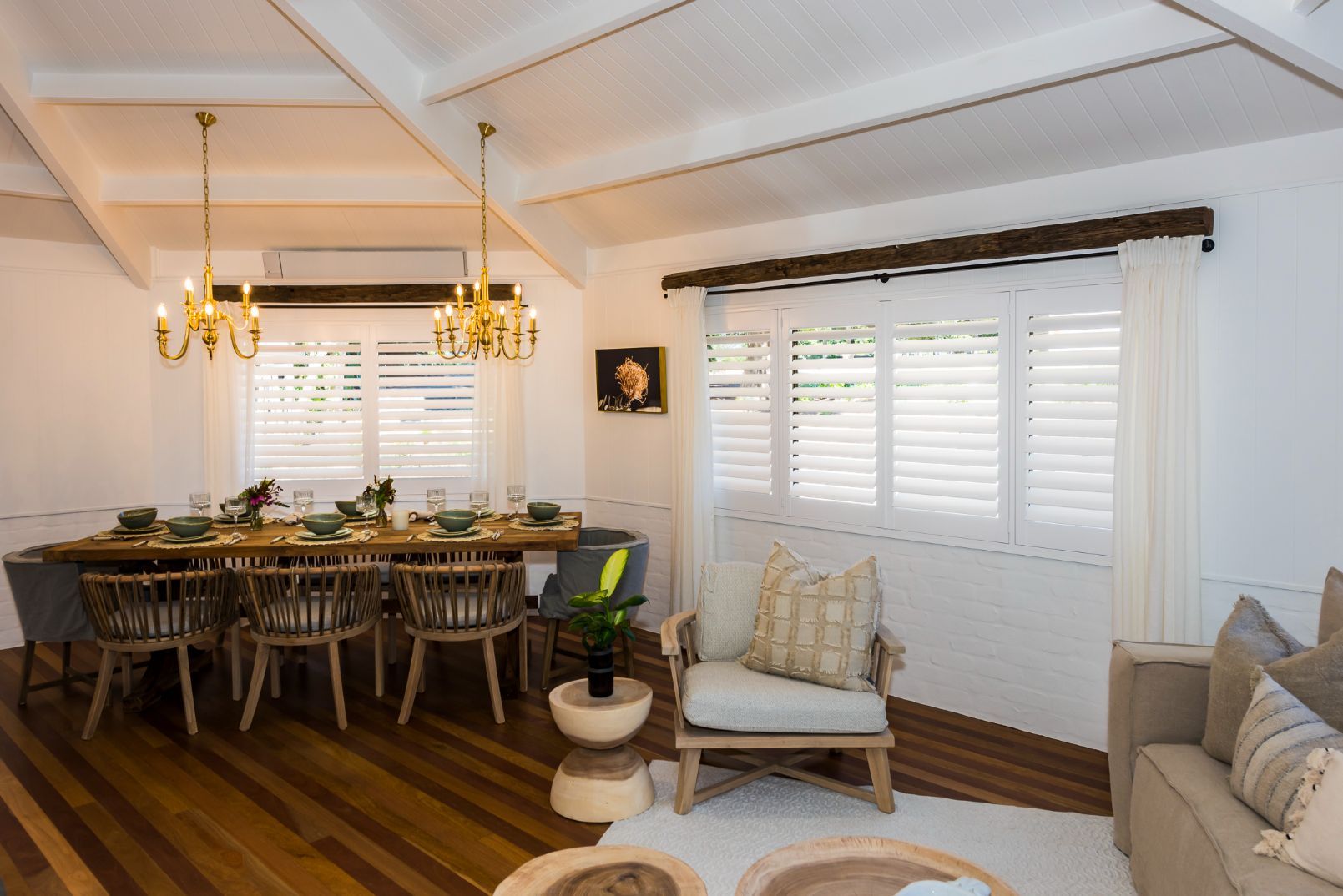 A Living Room With A Dining Table And Chairs And A Couch — TT Shutters & Shading In Ballina, NSW