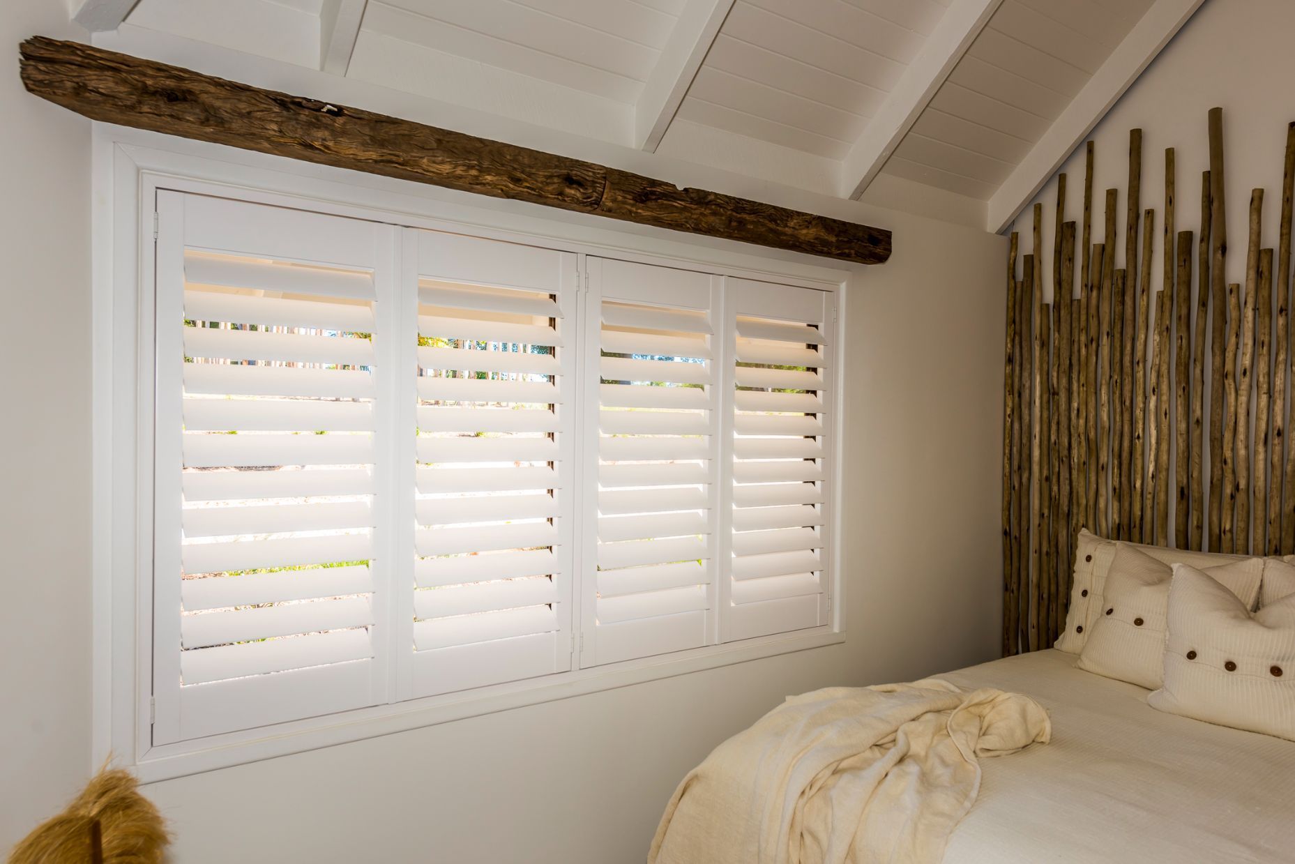 A Pair of Wooden Shutters on a Window With Trees in the Background — TT Shutters & Shading In Tweed Heads, NSW