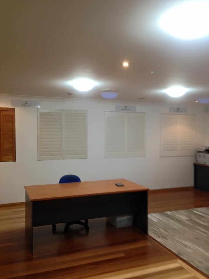 A Room With a Desk and Chair with Shutters at The Background — TT Shutters & Shading In Pottsville, NSW