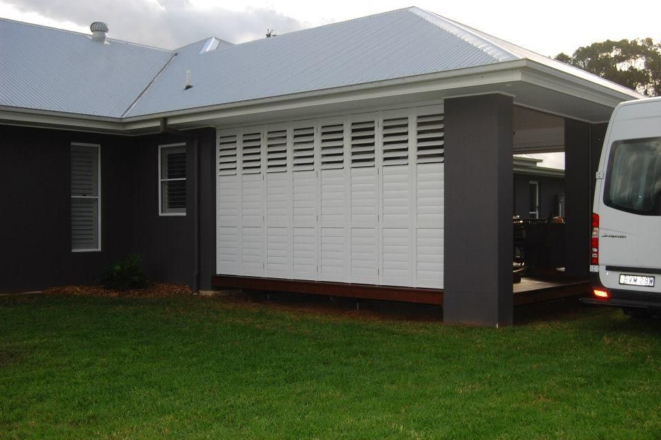 A White Van is Parked in Front of a House — TT Shutters & Shading In Ocean Shores, NSW