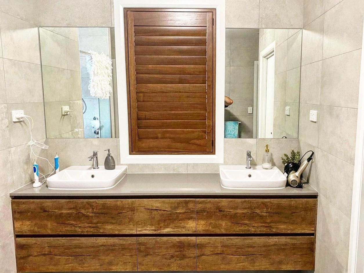 A Bathroom With Two Sinks and a Mirror — TT Shutters & Shading In Lismore, NSW