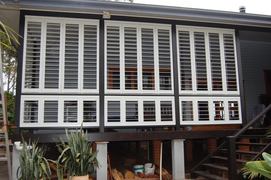 A House With a Lot of Windows and Shutters — TT Shutters & Shading In Ballina, NSW
